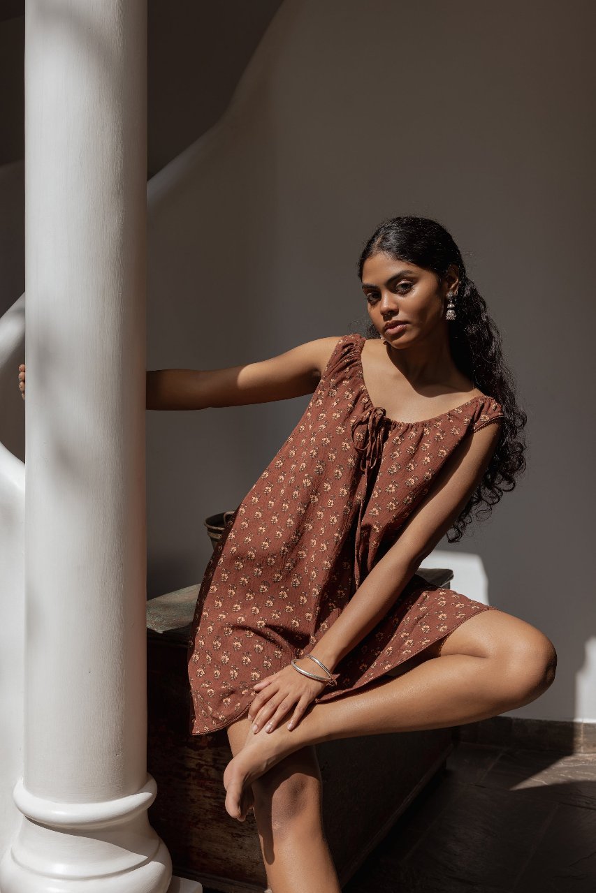 Sundress Mini Almond — model movement shot, mini dress hemline in motion, almond cotton sundress, sleeveless short dress, effortless summer style artisan India | Daughters of India