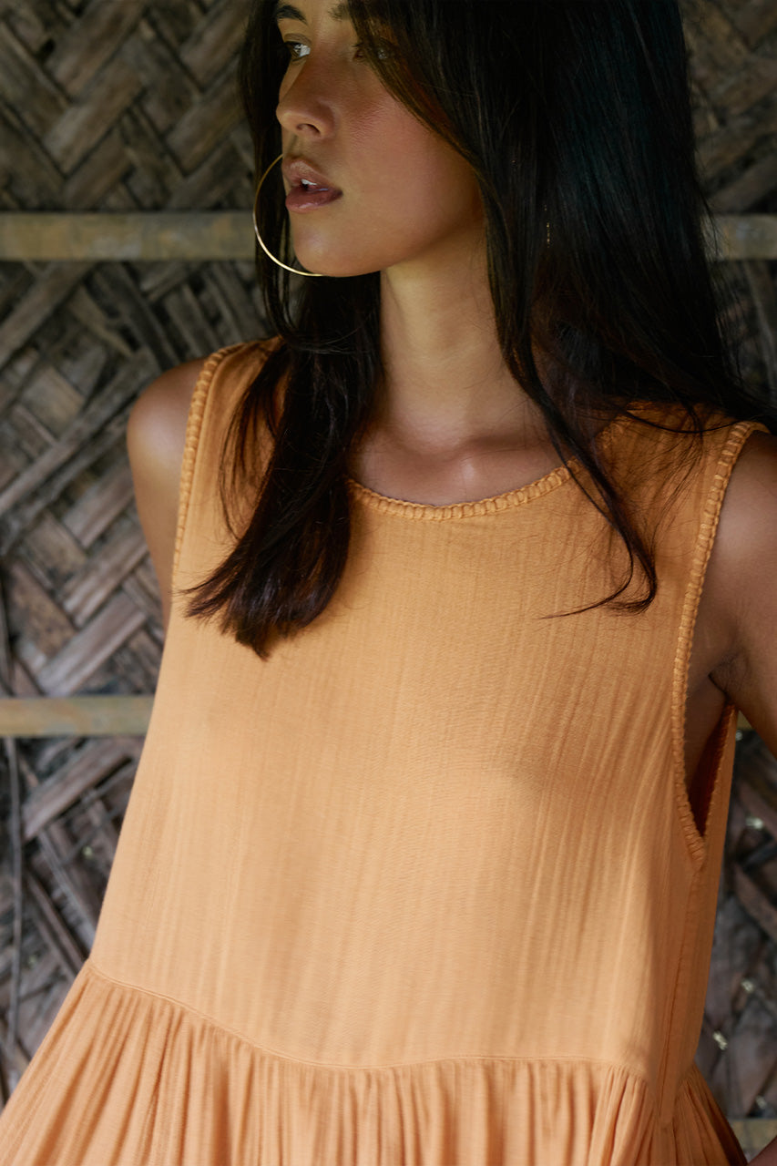 Nadi Dress Amber — neckline and fabric close-up, round neck sleeveless amber double gauze cotton with stitching detail, woven bamboo background | Daughters of India